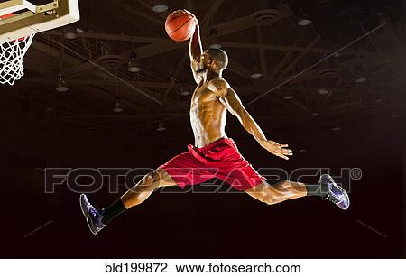 Stock Image - Black man playing basketball. Fotosearch