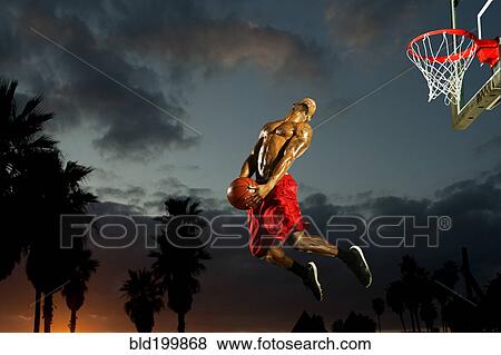 Stock Photo - Black man playing basketball. Fotosearch