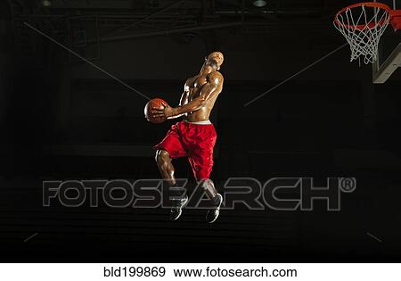 Stock Photo - Black man playing basketball. Fotosearch