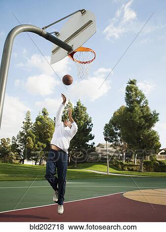 Stock Photo - Black man playing basketball. Fotosearch