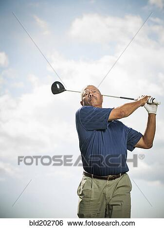 Stock Photograph - Black man playing golf. Fotosearch