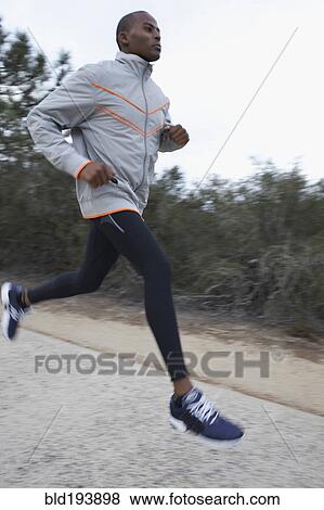 Stock Photo - Black man running on road. Fotosearch