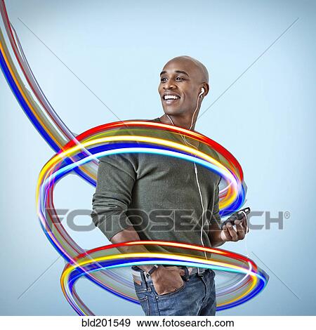 Stock Photo - Black man with mp3 player surrounded by colorful lines. Fotosearch