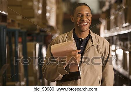 Black man working in warehouse View Large Photo Image Stock Image - Black man working in warehouse. Fotosearch
