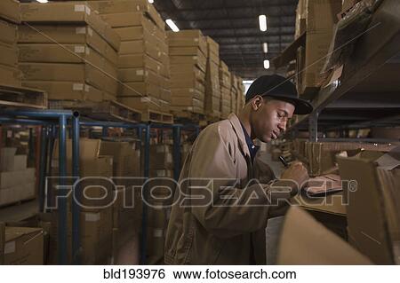 Stock Photograph - Black man working in warehouse. Fotosearch