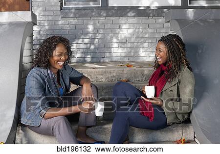Black mother and daughter sitting on front stoop drinking coffee View Large Photo Image Stock Image - Black mother and daughter sitting on front stoop drinking coffee. Fotosearch