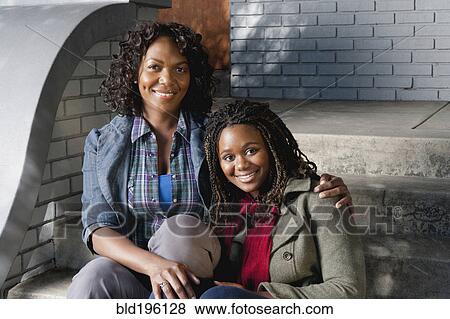 Black mother and daughter sitting on front stoop View Large Photo Image Stock Photo - Black mother and daughter sitting on front stoop. Fotosearch