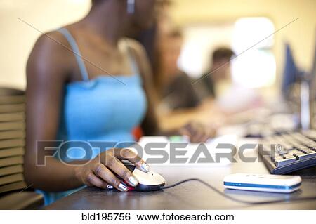 Stock Photograph - Black student using computer mouse in computer lab. Fotosearch