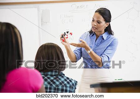 Black teacher showing students chemistry model View Large Photo Image Stock Image - Black teacher showing students chemistry model. Fotosearch