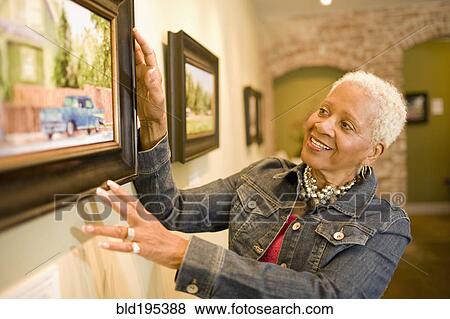Black woman admiring painting in gallery View Large Photo Image Stock Photo - Black woman admiring painting in gallery. Fotosearch