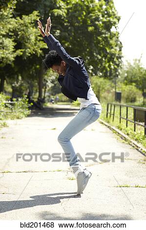 Black woman balancing on toes in park View Large Photo Image Stock Photo - Black woman balancing on toes in park. Fotosearch
