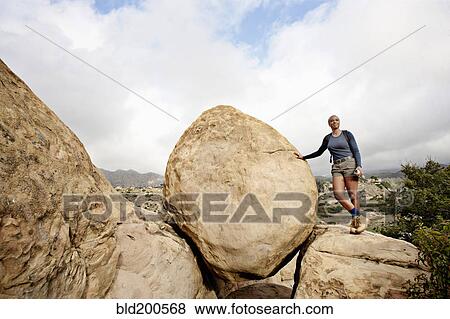 Black woman leaning against rock View Large Photo Image Stock Photo - Black woman leaning against rock. Fotosearch