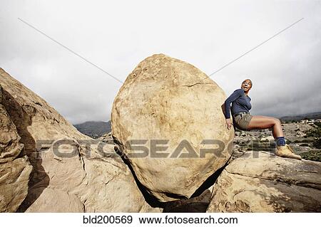 Black woman pushing large rock View Large Photo Image Stock Photo - Black woman pushing large rock. Fotosearch