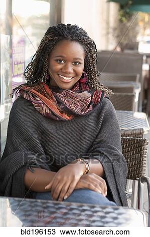 Black woman sitting at outdoor cafe View Large Photo Image Stock Image - Black woman sitting at outdoor cafe. Fotosearch