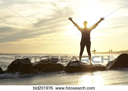 Black woman with arms raised on beach View Large Photo Image Stock Photograph - Black woman with arms raised on beach. Fotosearch