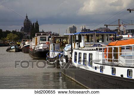 Stock Photography - Boats on Amsterdam canal. Fotosearch
