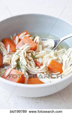 Stock Photo - Bowl of chicken and carrot soup. Fotosearch
