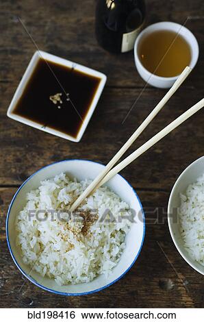Bowl of rice and chopsticks with sauces View Large Photo Image Stock Photograph - Bowl of rice and chopsticks with sauces. Fotosearch