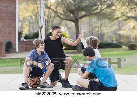 Boys sitting with basketball View Large Photo Image Stock Photography - Boys sitting with basketball. Fotosearch