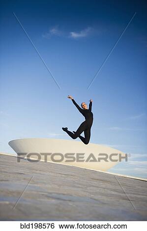 Brazilian dancer jumping in mid-air outdoors View Large Photo Image Stock Photograph - Brazilian dancer jumping in mid-air outdoors. Fotosearch
