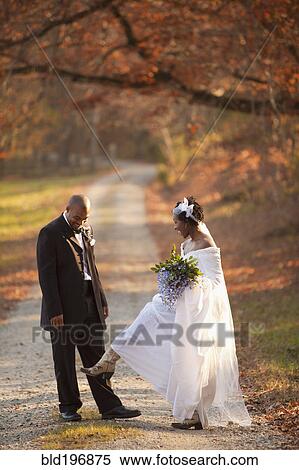 Bride and groom standing on path View Large Photo Image Stock Photography - Bride and groom standing on path. Fotosearch