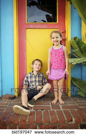 Stock Photo - Brother and sister sitting on front stoop. Fotosearch