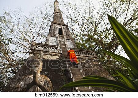 Buddhist monk climbing temple stairs View Large Photo Image Stock Photo - Buddhist monk climbing temple stairs. Fotosearch