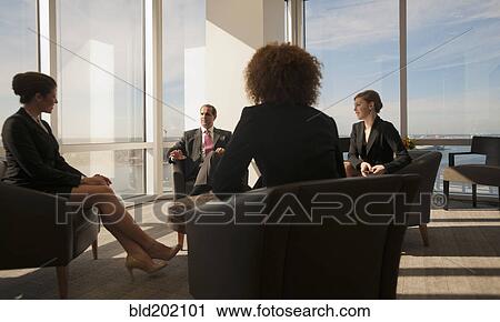 Stock Image - Business people having informal meeting. Fotosearch