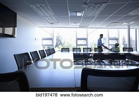 Business people shaking hands in conference room View Large Photo Image Stock Photo - Business people shaking hands in conference room. Fotosearch