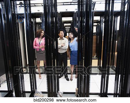 Business people talking in server room View Large Photo Image Stock Photo - Business people talking in server room. Fotosearch