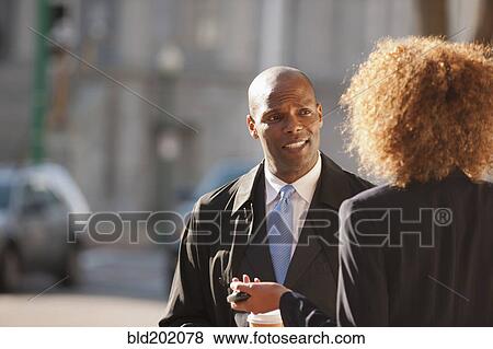 Stock Photo - Business people talking together outdoors. Fotosearch