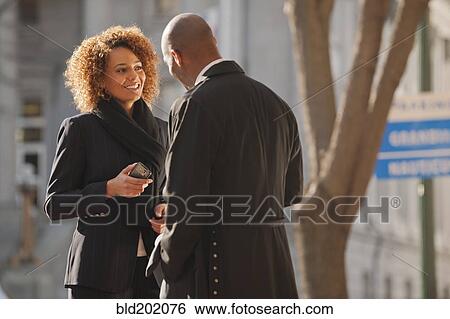 Stock Photograph - Business people talking together outdoors. Fotosearch