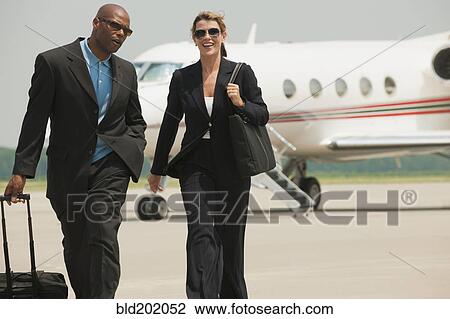 Business people walking on airport tarmac View Large Photo Image Stock Image - Business people walking on airport tarmac. Fotosearch