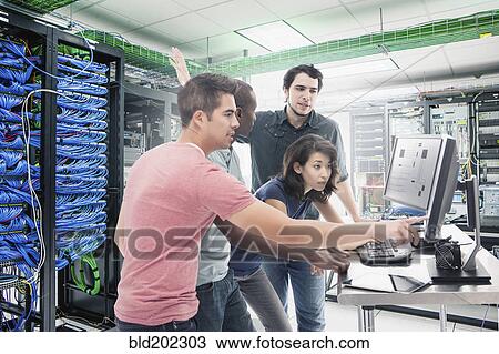 Business people working in server room View Large Photo Image Stock Image - Business people working in server room. Fotosearch
