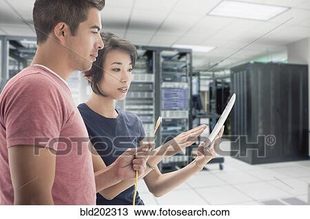 Business people working in server room View Large Photo Image Stock Image - Business people working in server room. Fotosearch