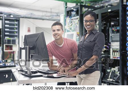 Stock Photo - Business people working in server room. Fotosearch