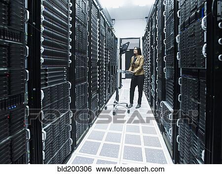 Stock Photograph - Business people working in server room. Fotosearch