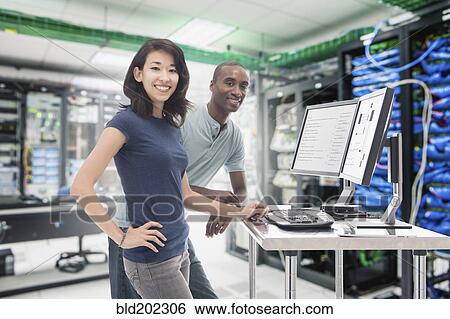 Stock Photograph - Business people working in server room. Fotosearch
