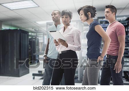 Stock Photography - Business people working in server room. Fotosearch