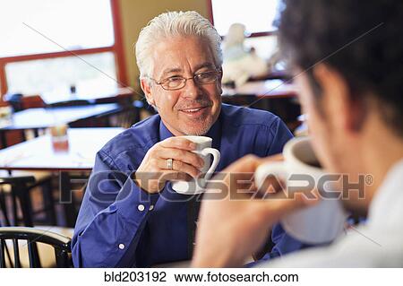 Businessmen having coffee together in cafe View Large Photo Image Stock Image - Businessmen having coffee together in cafe. Fotosearch