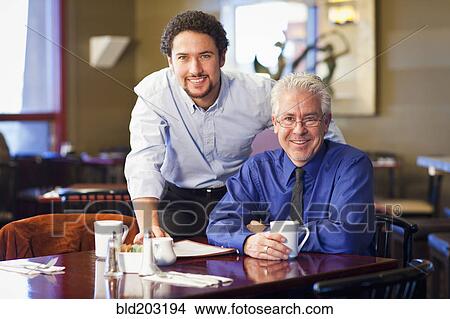 Businessmen smiling together in cafe View Large Photo Image Picture - Businessmen smiling together in cafe. Fotosearch