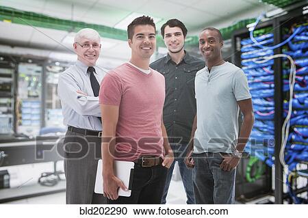 Businessmen standing in server room View Large Photo Image Stock Image - Businessmen standing in server room. Fotosearch