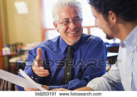 Businessmen talking in cafe View Large Photo Image Stock Image - Businessmen talking in cafe. Fotosearch