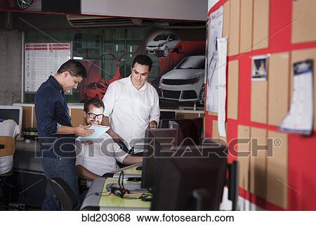 Stock Photo - Businessmen talking in office. Fotosearch