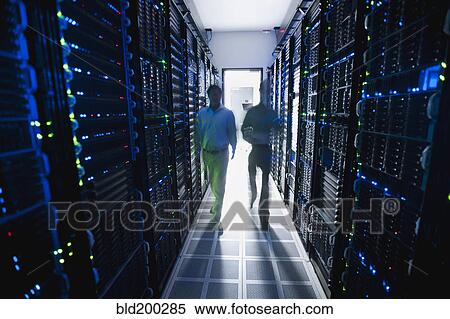 Stock Photography - Businessmen walking in server room. Fotosearch