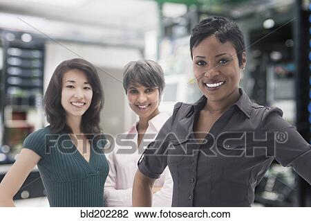 Businesswomen standing in server room View Large Photo Image Stock Image - Businesswomen standing in server room. Fotosearch