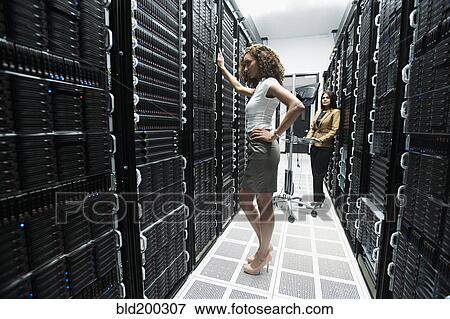 Stock Photo - Businesswomen working in server room. Fotosearch