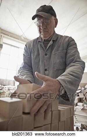 Carpenter stacking wood in woodshop View Large Photo Image Stock Image - Carpenter stacking wood in woodshop. Fotosearch