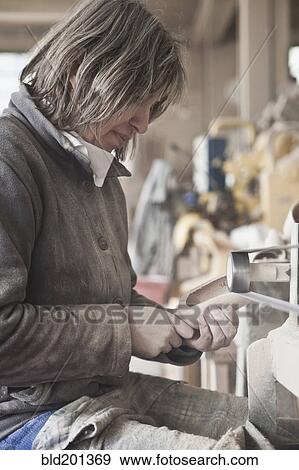 Stock Photo - Carpenter working in woodshop. Fotosearch