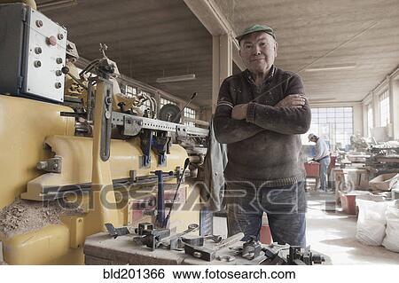 Carpenter working in woodshop View Large Photo Image Stock Photograph - Carpenter working in woodshop. Fotosearch